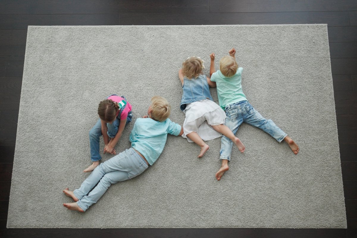 Kids playing on clean carpet after professional rug cleaning